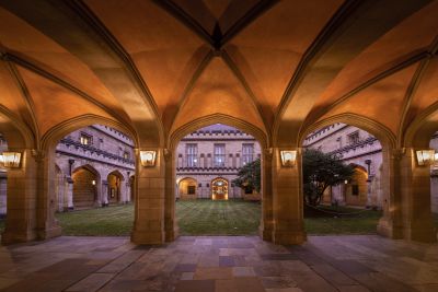 The sandstone Old Quad with a courtyard lawn and camellia tree in the centre