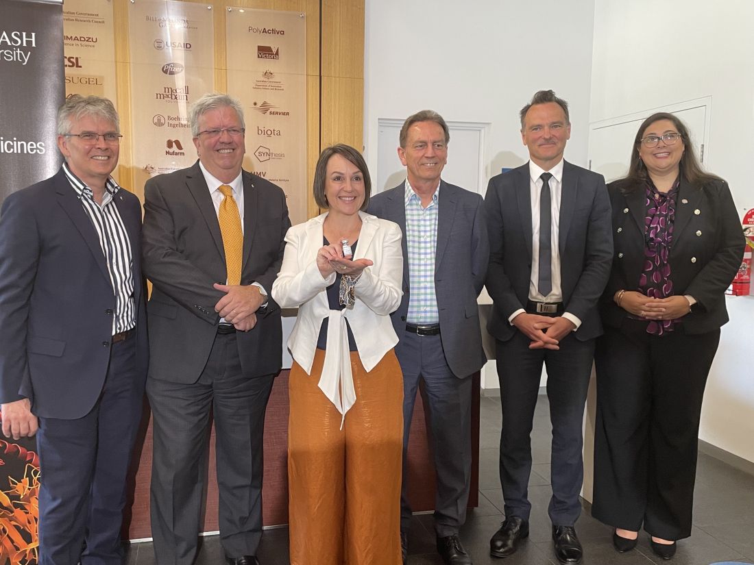 Researchers and Minister Jaala Pulford with a vial of an mRNA vaccine developed and manufactured in Victoria.