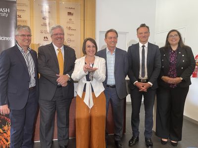 Researchers and Minister Jaala Pulford with a vial of an mRNA vaccine developed and manufactured in Victoria.