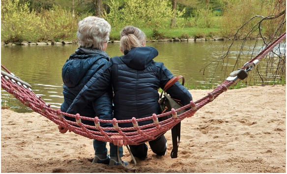 Image of an elderly lady and her daugther sitting together.