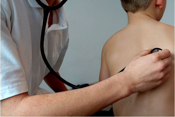 Image of a doctor examinaning a child with a stethoscope.