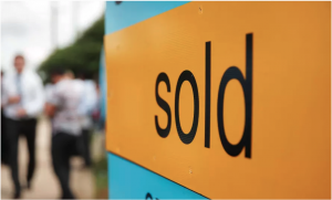 Image of a board with sold written on it.