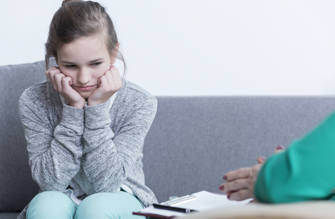 Young child looking sad in a counselling session