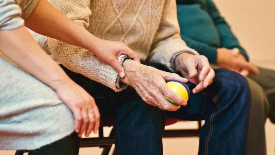 Image of elderly people holding hands.