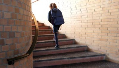 School student walking up the stairs